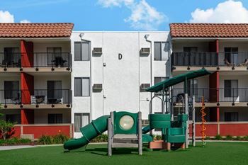 a childrens playground in front of an apartment building